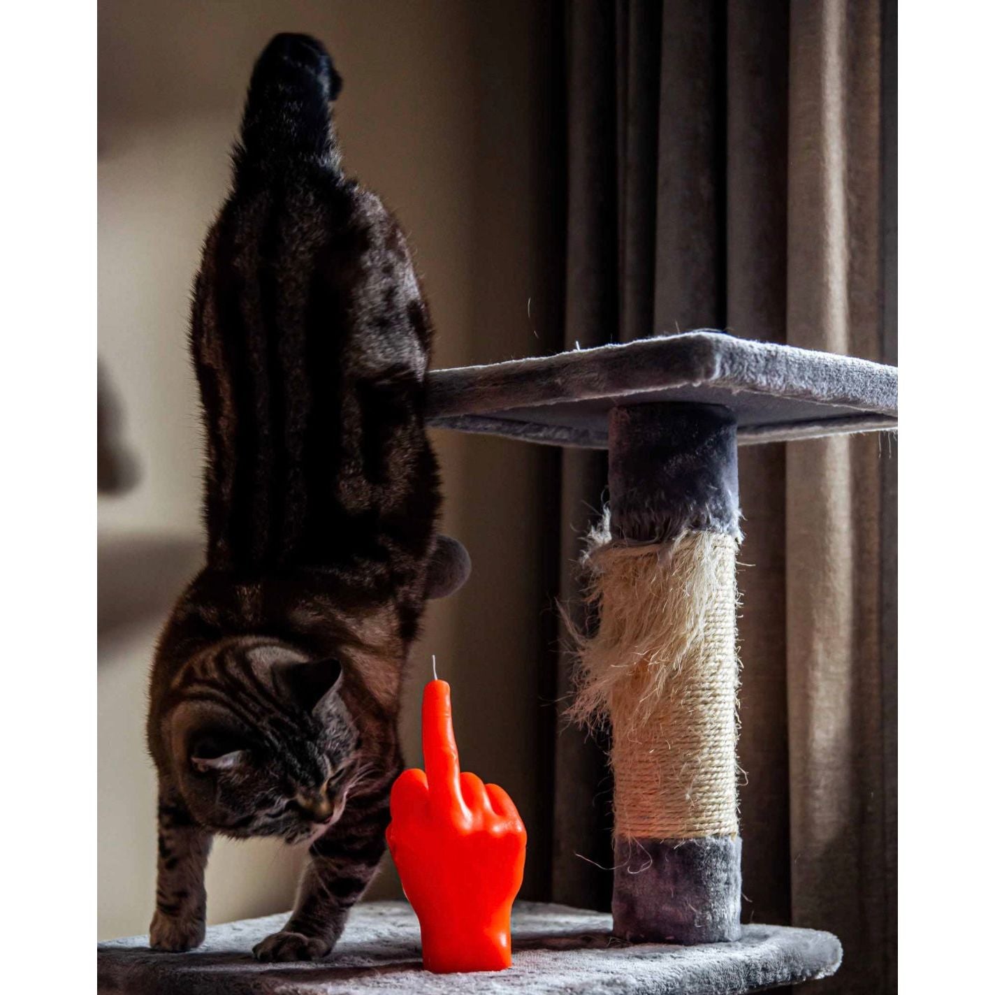 Bougie Candlehand fluo orange en forme de main faisant un doigt d’honneur