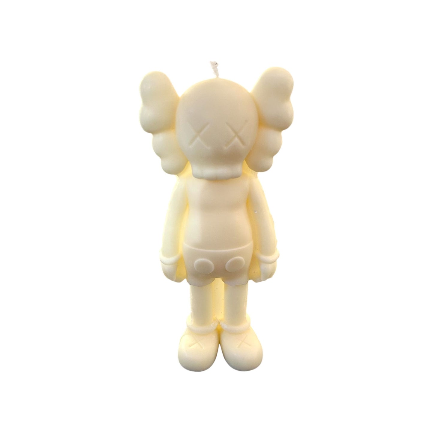 Bougie design ivoire représentant une figurine Companion inspirée de KAWS