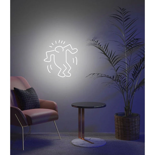 Néon mural Dancing Man blanc – Keith Haring x Yellow Pop, allumé dans une pièce cosy