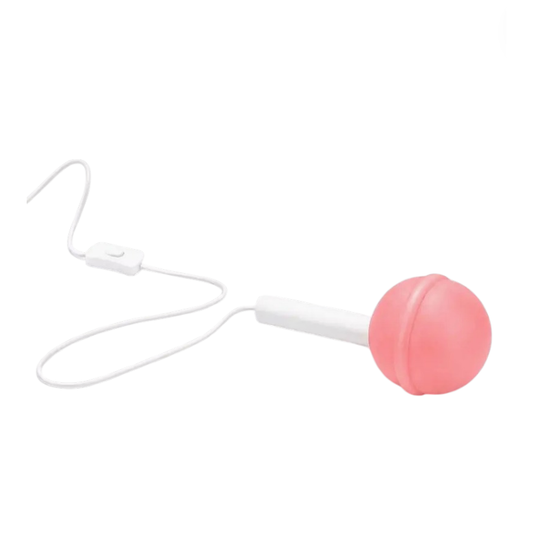 Lampe Sucette L'Expressionist rose à poser diffusant une lumière d'ambiance douce dans un intérieur contemporain
